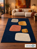 Basel Lantern Nocturne: hand-tufted wool rug in midnight blue, ochre, terracotta, stone grey and ivory, in a modern living room with coordinated art.