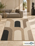 Bern Arcade Rhythm: hand-tufted wool rug in sandstone beige, ivory, taupe and charcoal, in a modern living room with coordinated art.