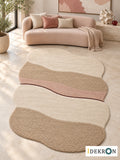 Zug Kirsch Layers: hand-tufted wool rug in cream, biscuit beige, dusty rose and dark cherry red, in a modern living room with coordinated art.